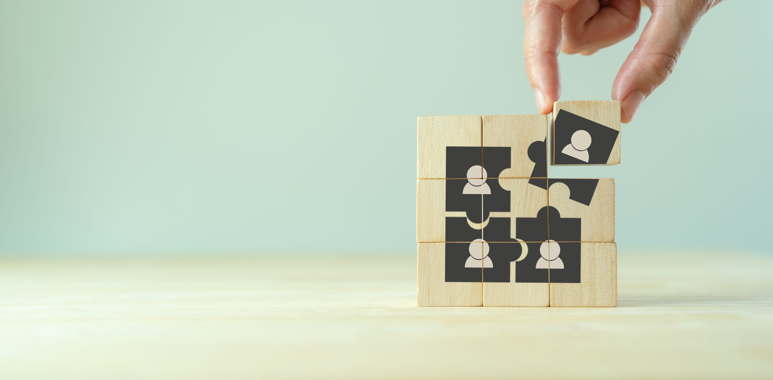 Hand completing a wooden puzzle