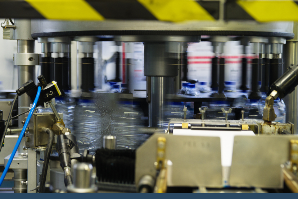 Labels being applied to items as they pass through an automated production line