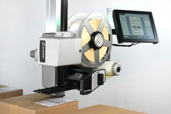Evolabel applicator applying labels to a cardboard box