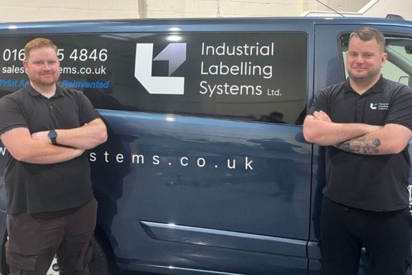 Two men stand in front of an Industrial Labelling Systems van