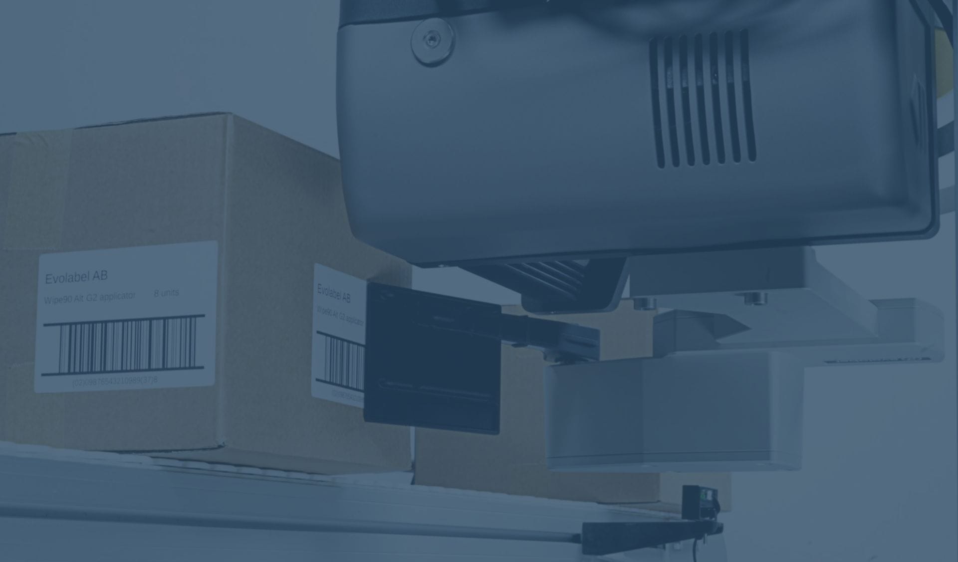 Evolabel Wipe G2 applying labels to cardboard boxes