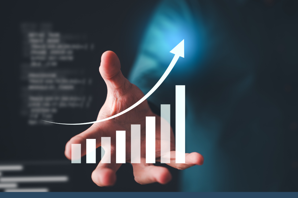 An open hand, in front is a graphic showing a graph with an arrow in an upward direction.